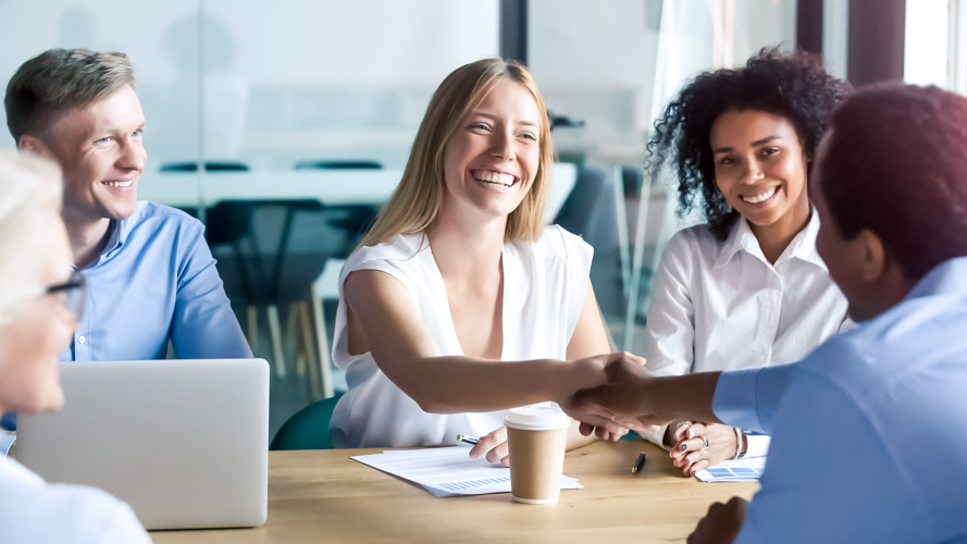 People in a meeting shaking hands